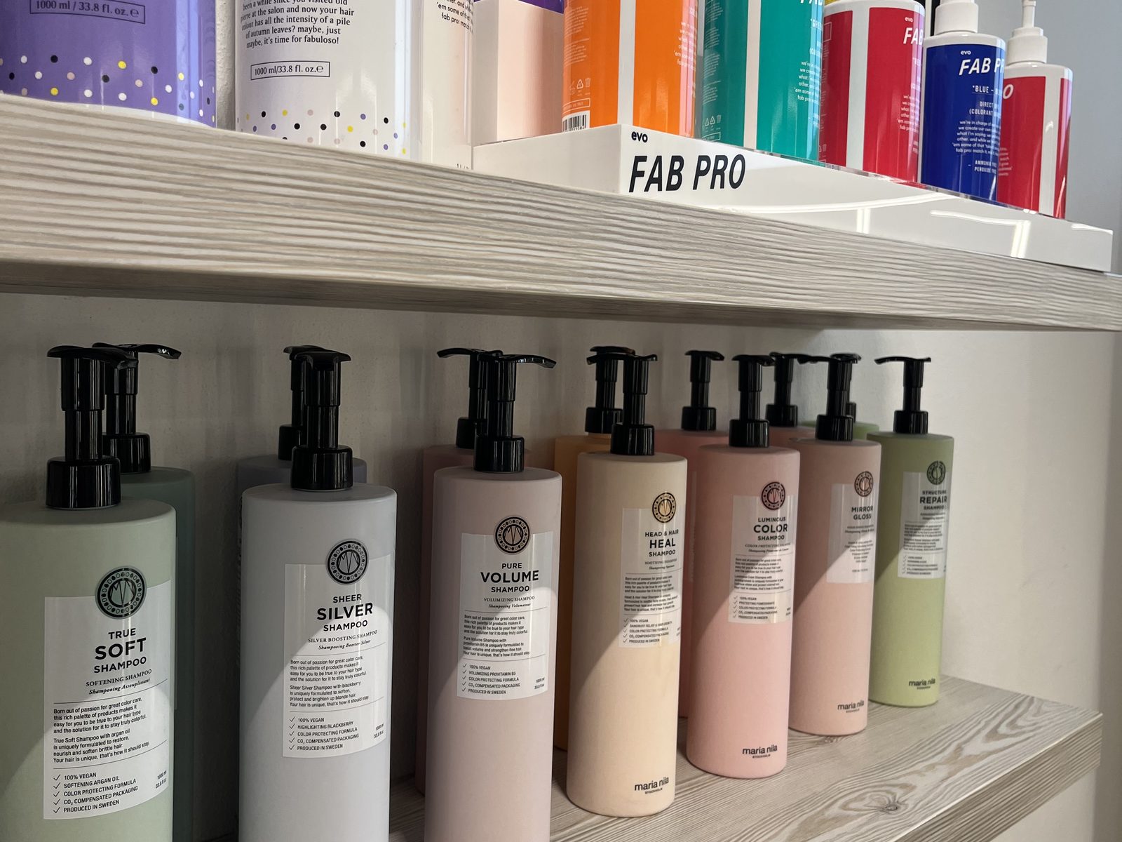 Maria Nila and evo care products on the shelf at HAIRLODGE Ellmau.