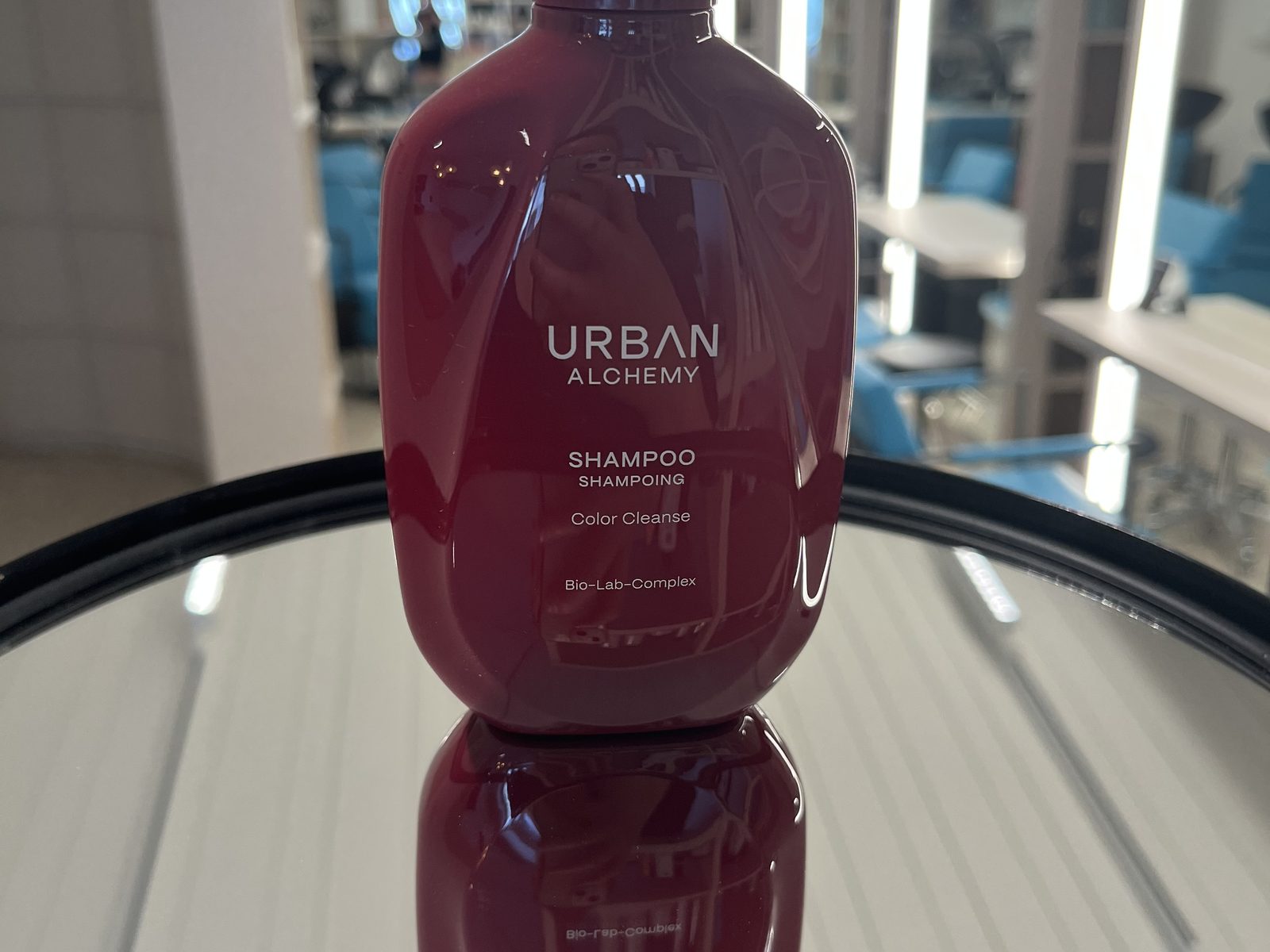 Urban Alchemy Colour Cleanse shampoo on the mirrored table at HAIRLODGE Ellmau.